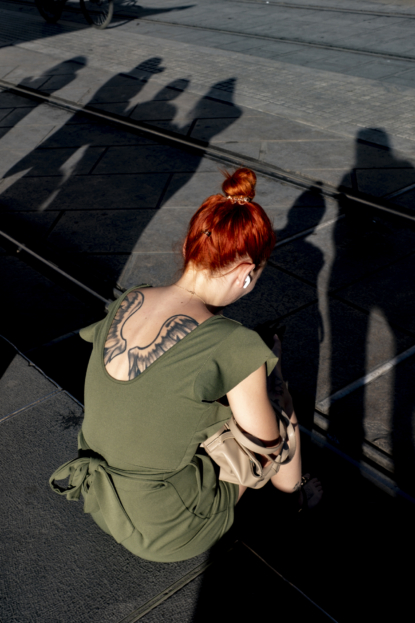 Waiting for the tram, this young lady with her beautiful Angel Wings tattoo is hit by the sunlight.